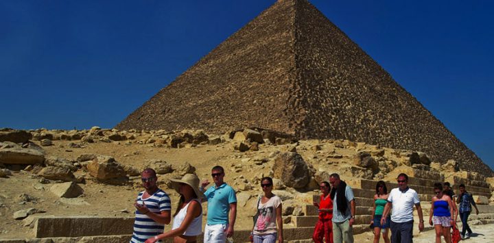 3-tourists-waiking-by-pyramids
